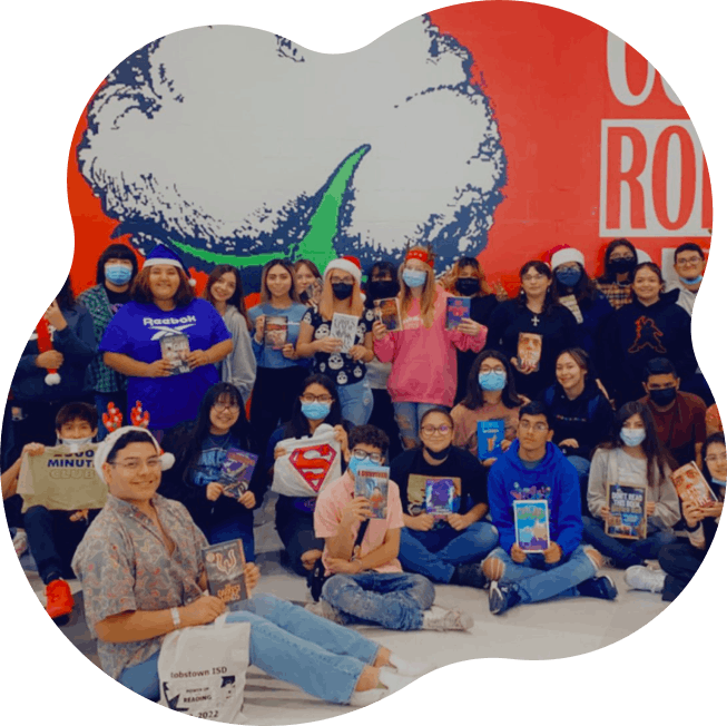 Group of high school students displaying reading challenge rewards including books and tee shirts