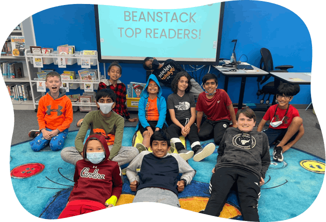 Middle school students celebrating being top readers in Beanstack school reading challenge