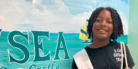 A Sea Castle Elementary student reading ambassador